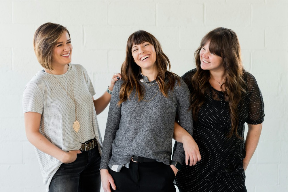 Three women laughing together
